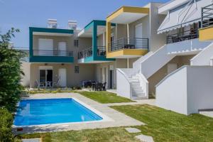 an apartment building with a swimming pool in front of it at Danai Apartment with pool Access in Ofrínion