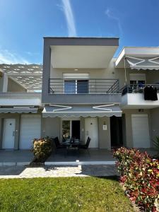 a large house with a balcony and a patio at Danai Apartment with pool Access in Ofrínion