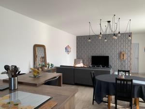 a living room with a couch and a table at Maison Benclé in Vaux-sur-Mer