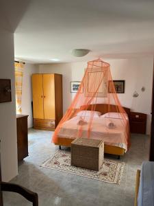 a bedroom with a bed with a net on it at A casa di Maria Antonietta in Il Monte