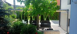 a patio with two black chairs and trees at Willa S&F in Maniowy