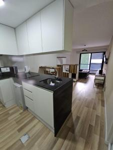 a kitchen with a black counter top in a room at Alquiler Temporario Rosario 24 in Rosario +4 photos