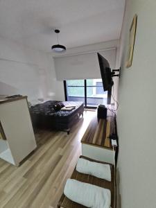 a living room with a bed and a couch at Alquiler Temporario Rosario 24 in Rosario