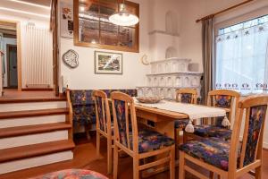 a dining room with a wooden table and chairs at Casa Pini By Go new location in Moena