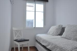 a bedroom with a bed and a window and a table at Casa Sandra in Arcos de la Frontera