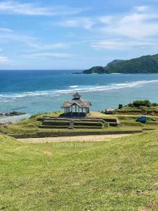 a gazebo on a hill next to the ocean at Putri Nyale Bungalows & Rooms in Kuta Lombok