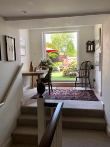 a room with a staircase with a table and a window at The Cricketers House in Marlborough +35 photos