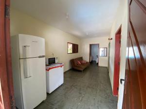 a living room with a refrigerator and a couch at Porto Mirim House in Ceará-Mirim