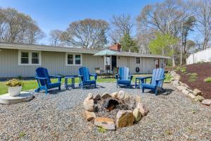 a backyard with chairs and a fire pit at Steps to Beaches and Main Street Hyannis Retreat in Hyannis