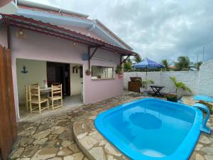 a villa with a swimming pool in front of a house at Porto Mirim House in Ceará-Mirim
