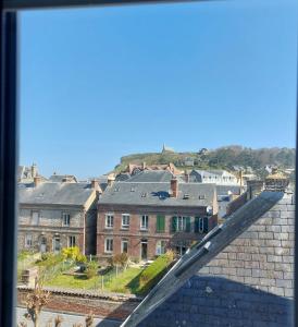 a view of a city from the top of a building at Les Vagues - Séjour Plage et Falaises au centre d'Etretat in Étretat +2 photos