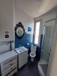 a bathroom with a toilet and a sink and a mirror at Les Vagues - Séjour Plage et Falaises au centre d'Etretat in Étretat