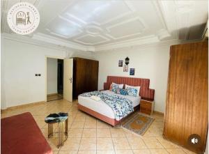 a bedroom with a bed and a couch at Hotel Merry in Agadir +10 photos