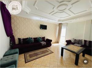 a living room with a couch and a table at Hotel Merry in Agadir