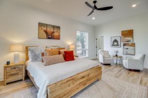 a bedroom with a bed and a ceiling fan at 3 Mi to Winery Jasper Mountain Chalet with Hot Tub! in Jasper +37 photos