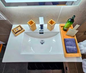 a bathroom sink with a bottle of alcohol on it at The Royal Manor Inn in Niagara-on-the-Lake