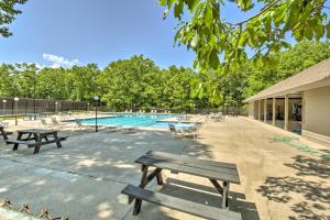 a swimming pool with benches and a picnic table at 3 Mi to Winery Jasper Mountain Chalet with Hot Tub! in Jasper