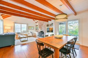 a dining room and living room with a table and chairs at Walk to Amagansett Beach Cottage with Deck! in Amagansett