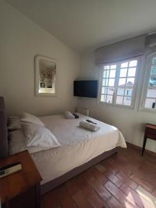 a bedroom with a bed with two towels on it at Petite maison de pecheur in Grimaud