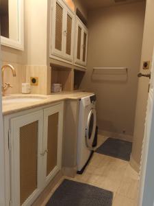 a laundry room with a washer and dryer at Petite maison de pecheur in Grimaud +21 photos