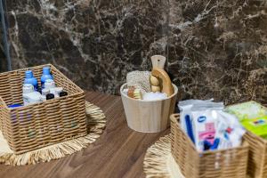 a table with two baskets and bottles on it at Palace Apartmans in Sremska Mitrovica