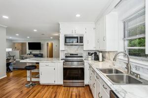 a kitchen with white cabinets and stainless steel appliances at 2967 Swan Lane in Pensacola