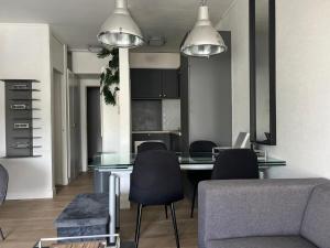 a dining room with a glass table and chairs at 2 bedroom apartment at Knokke-Heist, near Zeebrugge, overlooking the lake in Knokke-Heist