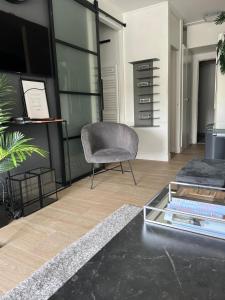 a living room with a couch and a chair at 2 bedroom apartment at Knokke-Heist, near Zeebrugge, overlooking the lake in Knokke-Heist