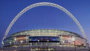 a large building with an arch at night at Modern House with Free Parking near Wembley in London