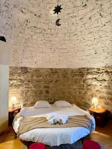 a bedroom with a bed with two stuffed animals on it at La tour du Château - Jacuzzi sur le toit in La Léchère