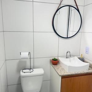 a bathroom with a sink and a toilet and a mirror at 81NV Studio Liberdade SP 300 Metros Estação Japão até 03 pessoas in São Paulo +32 photos