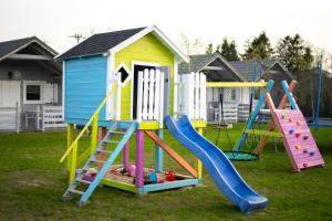 a playground with a slide and a play house at FHU Aquarius in Dziwnówek