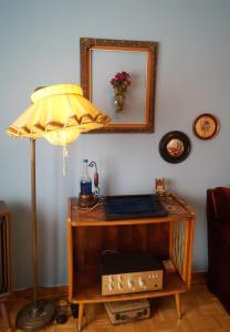 a desk with a lamp and a mirror on a wall at Retro private room in common apartment in Athens +6 photos