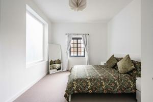 un dormitorio con una cama y una ventana en The Old Post Office, en Norwich