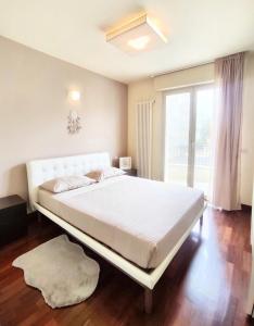 a large white bed in a room with a window at Bluemar Dolcemare - 105mq in Cattolica