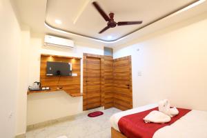 a bedroom with a bed and a ceiling fan at The Brij Vista in Mathura