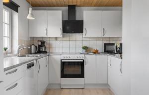 a white kitchen with white cabinets and appliances at Gorgeous Home In Harboøre With Sauna in Harboør