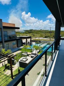 a view from the balcony of a resort with a swimming pool at Casa da Alê in Camaçari