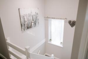 a white room with a window and a picture on the wall at Pendle Close - 3 bed house with parking in Peterlee +35 photos
