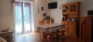 a living room with a table and a window at Nice studio in the heart of Le Monêtier-les-Bains in Le Monêtier-les-Bains