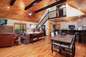 a kitchen and living room with a wooden ceiling at Mountain Melody in Morganton