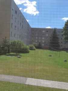 a large building with a grass field in front of it at Apartment Fritz in Leipzig
