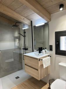 a bathroom with a shower and a sink and a toilet at Cabana Blanca Turisme Rural in Solsona