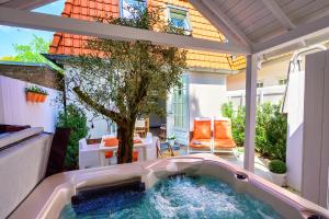 a pool in the middle of a patio with a tree at 5 O Clock Somewhere in Bergen