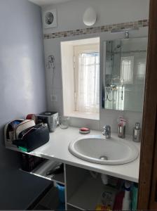 a bathroom counter with a sink and a mirror at La maussanaise in Maussane-les-Alpilles +8 photos