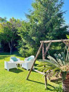 a couple of chairs sitting in the grass at Villa Joyosa Apartments in Ischia Town