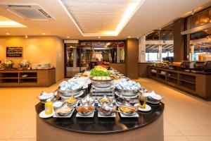 a buffet of food on a table in a restaurant at Kacha Resort & Spa, Koh Chang in Ko Chang