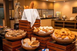 a display of bread and pastries in baskets on a table at Kacha Resort & Spa, Koh Chang in Ko Chang