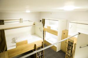 a room with two bunk beds and a staircase at Yassi HOSTEL in Türkistan