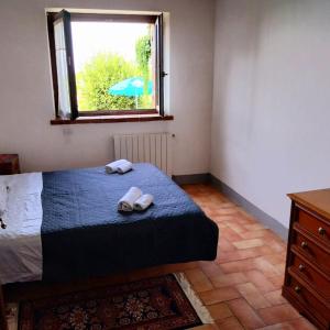 a bedroom with a bed with towels and a window at La Bella Vista in Collazzone +49 photos